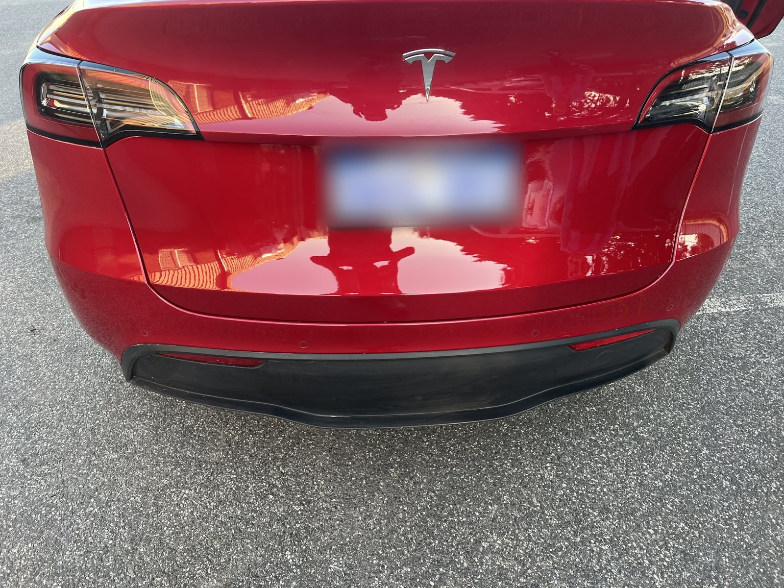 Rear of a red Tesla Model Y with a deep gloss finish